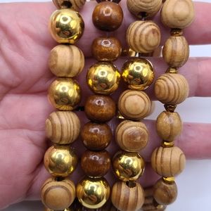4 bracelets. Woody. Brown and gold. Worn together or individually. Stretchy.